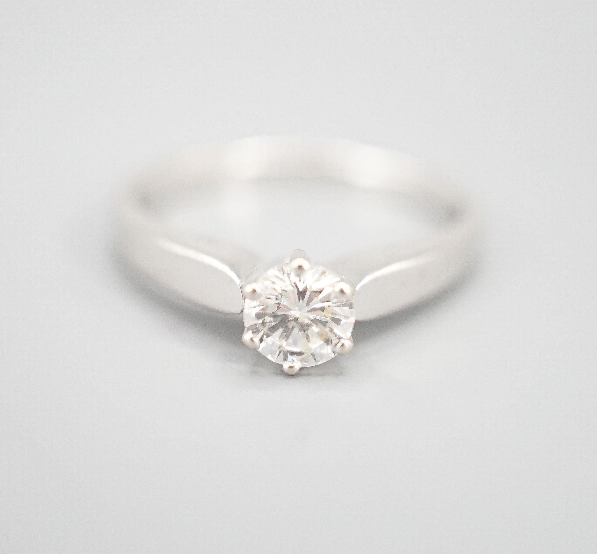 A modern white metal and solitaire diamond ring, size M, gross weight 2.3 grams.